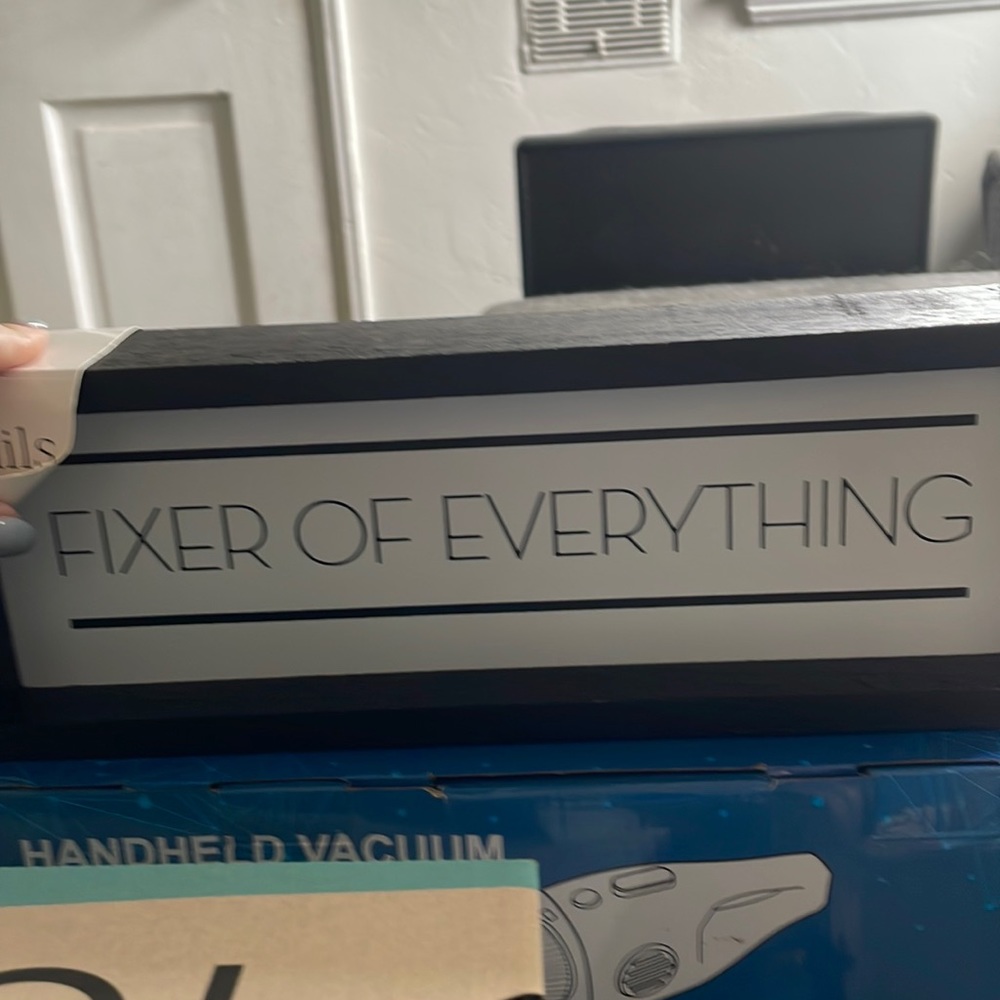 “Fixer of Everything” Sign